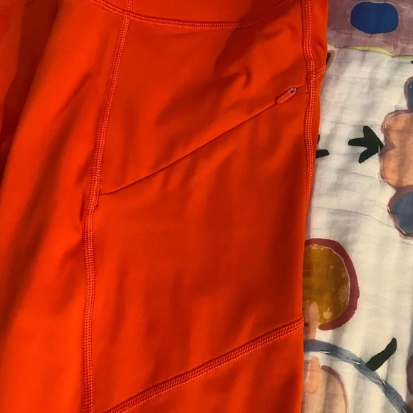 Athleta Orange leggings. Inside pocket for keys or money. Side zipper pockets. - Picture 3 of 5